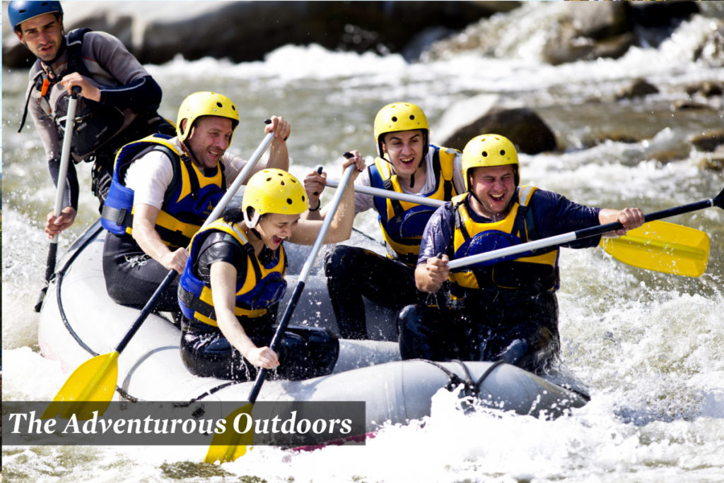 5 people white water rafting and smiling