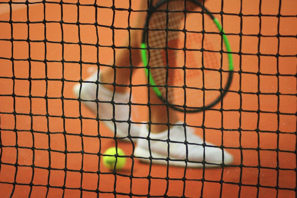 Tennis shoes behind a net