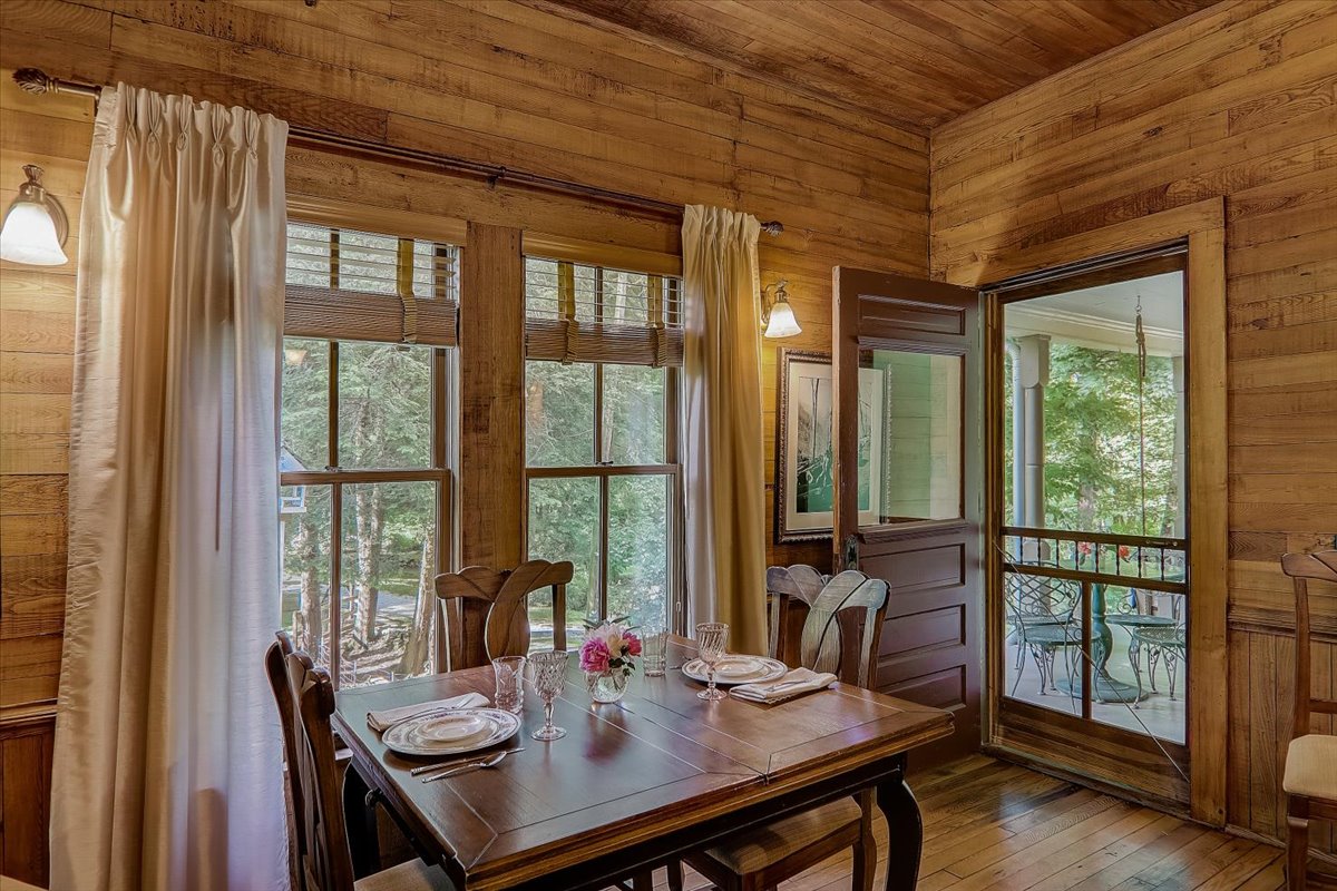 Main-floor-dining-room-with-door-to-side-porch-windows-overlooking-pasture