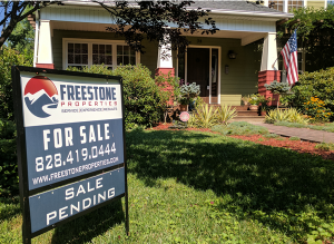 Image of Asheville home with a ‘For Sale’ sign in front of it.