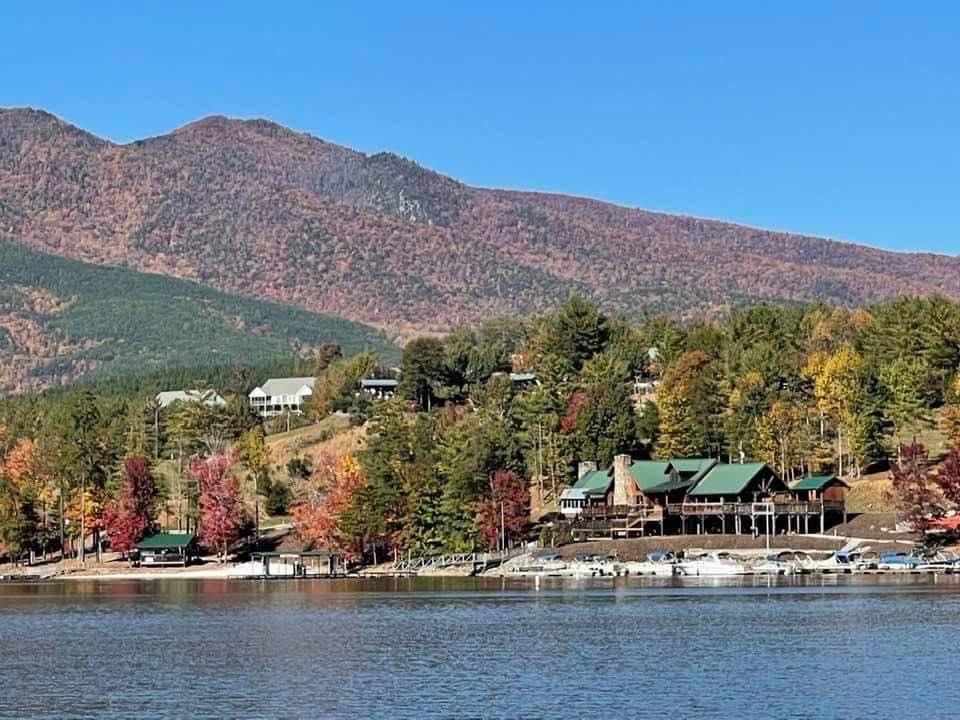 View of a marina with mountains in the background in fall colors