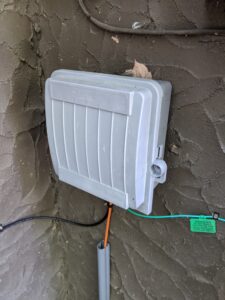 Cable box on the side of a house