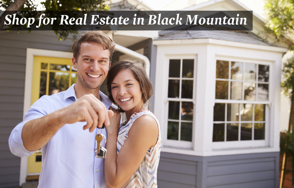 A couple holding the keys to their new home in Black Mountain.